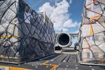 Air cargo pallets being loaded onto a freight aircraft